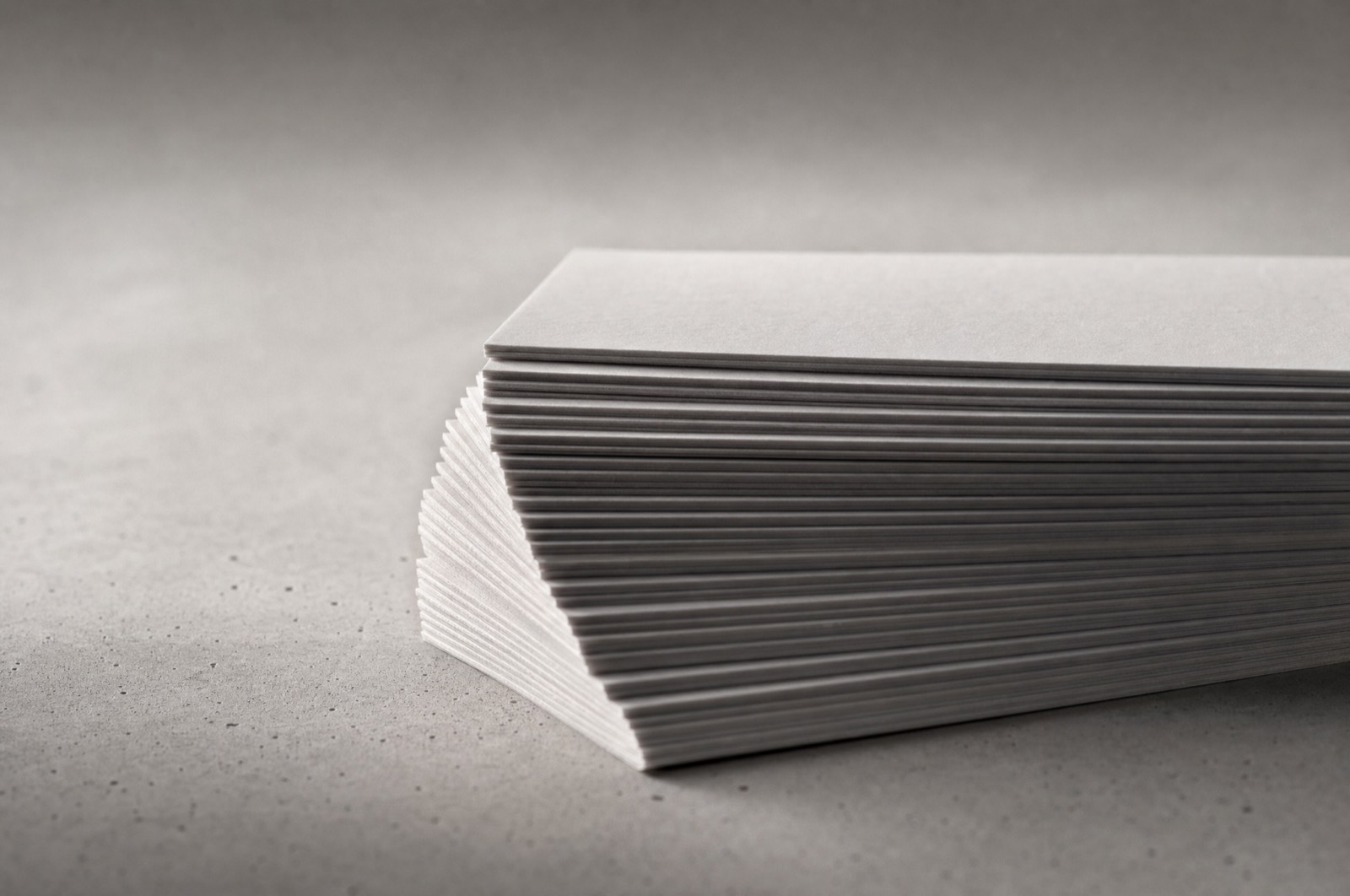 A stack of plain index cards seen edge on, slightly fanned